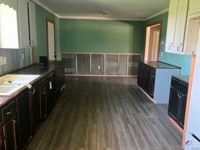 kitchen with dark wood-type flooring, white cabinets, dark brown cabinetry, and ornamental molding