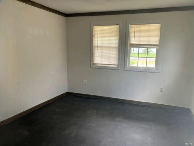 empty room featuring crown molding