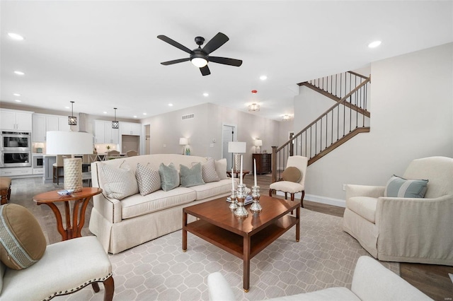 living area with visible vents, baseboards, ceiling fan, stairway, and recessed lighting