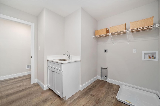 laundry room featuring hookup for an electric dryer, laundry area, washer hookup, wood finished floors, and a sink