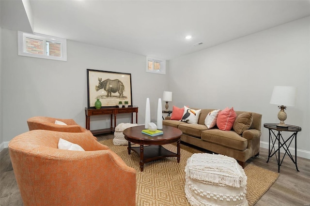 living area featuring recessed lighting, visible vents, baseboards, and wood finished floors