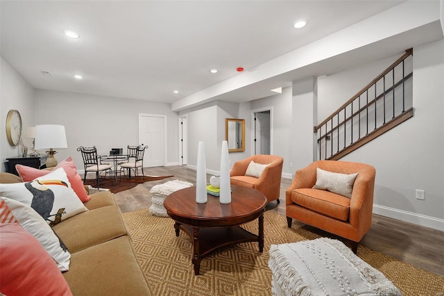 living area with recessed lighting, stairway, baseboards, and wood finished floors