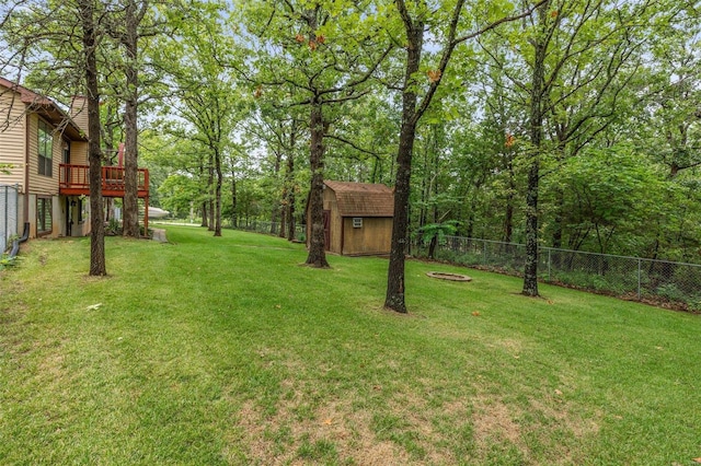 view of yard with a wooden deck and a shed