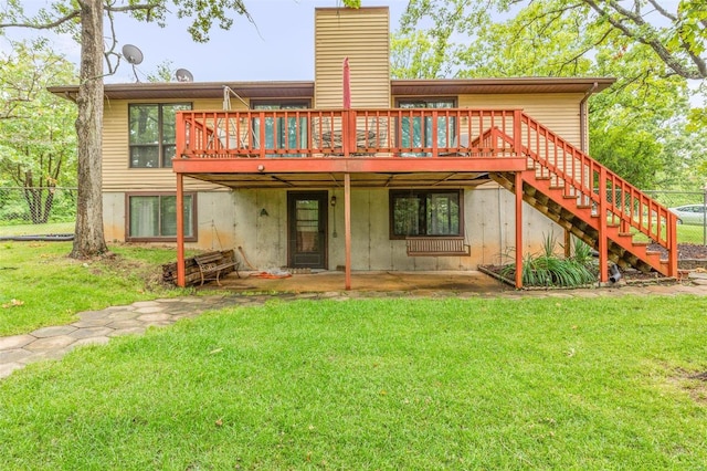 rear view of house with a deck and a lawn