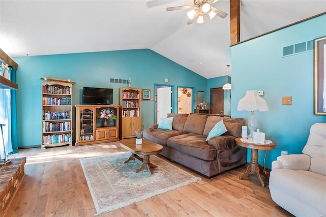 living room with light hardwood / wood-style flooring, ceiling fan, and high vaulted ceiling