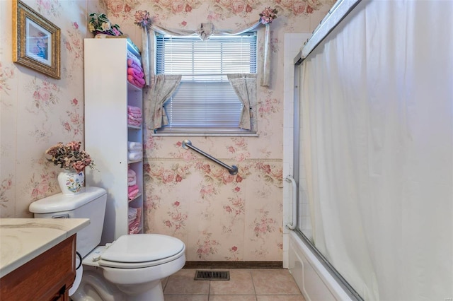 full bathroom featuring tile patterned floors, vanity, combined bath / shower with glass door, and toilet