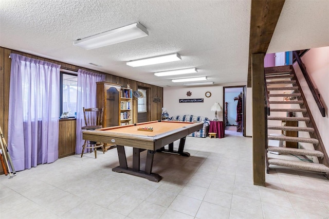 game room with light tile patterned floors, a textured ceiling, and billiards