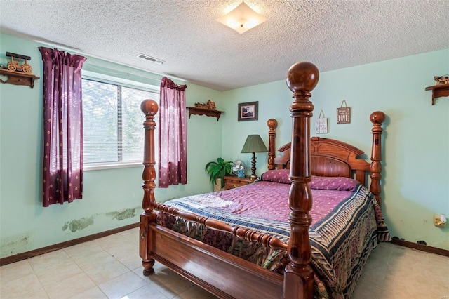 tiled bedroom with a textured ceiling