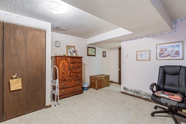 office space with tile patterned flooring and a textured ceiling