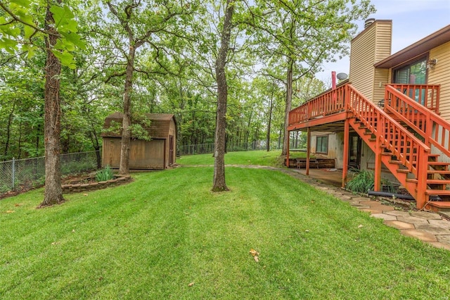 view of yard featuring a storage unit and a deck