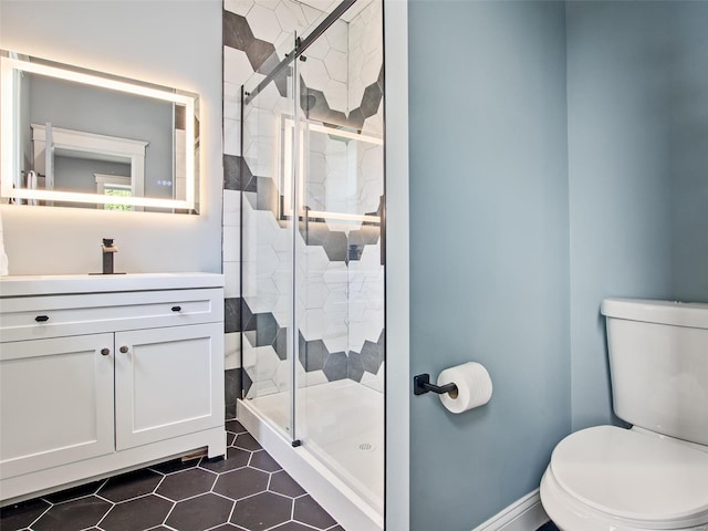 bathroom with vanity, an enclosed shower, and toilet