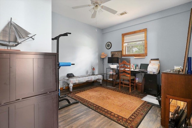home office featuring ceiling fan, visible vents, and wood finished floors