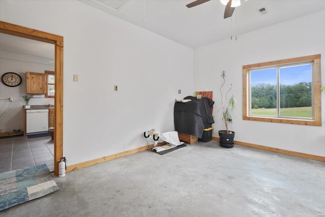 empty room featuring visible vents, a ceiling fan, concrete floors, baseboards, and attic access