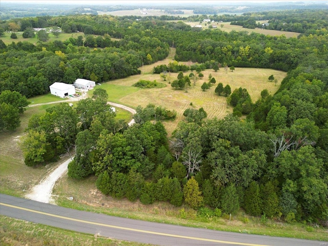 drone / aerial view featuring a forest view and a rural view