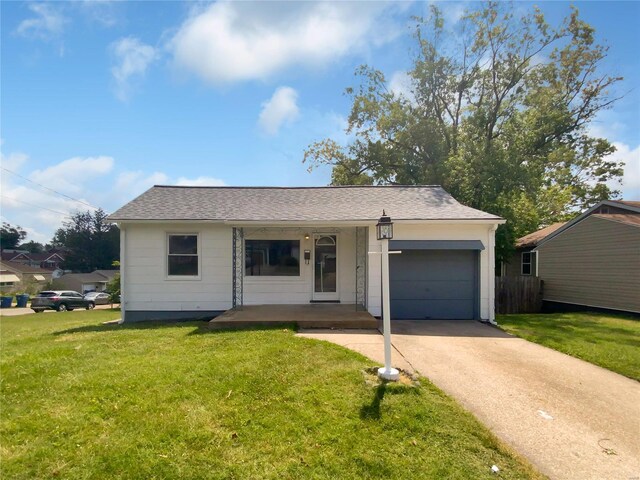 view of front of home with a porch, a garage, and a front lawn