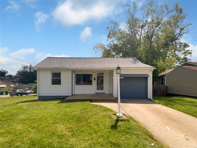 view of front of house with a garage, covered porch, and a front yard