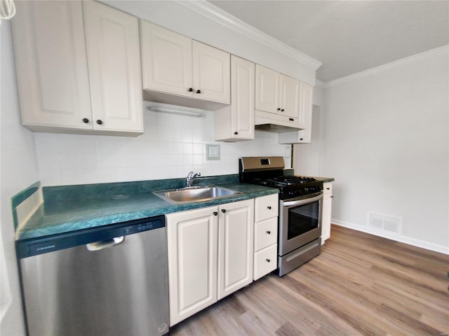 kitchen featuring white cabinetry, light hardwood / wood-style floors, appliances with stainless steel finishes, and sink