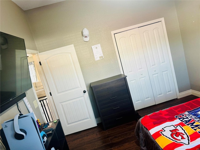 bedroom with a closet and dark hardwood / wood-style floors