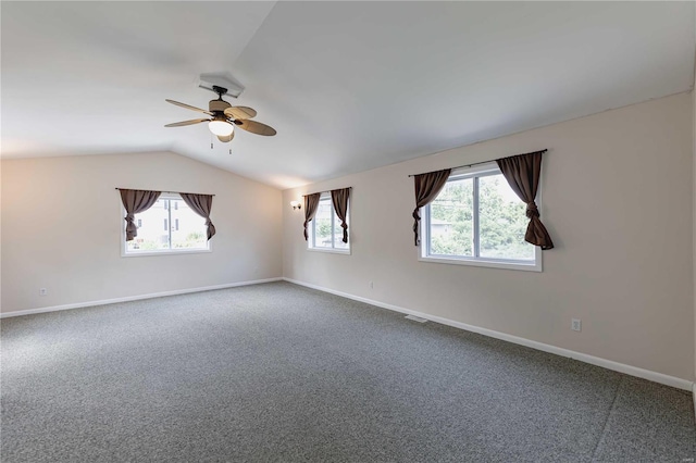 spare room featuring ceiling fan, plenty of natural light, carpet floors, and lofted ceiling