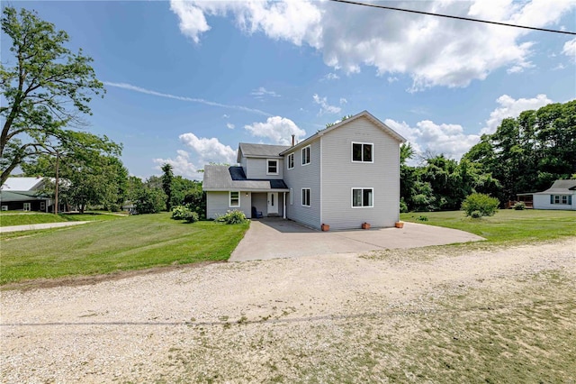 view of front of property with a patio area and a front yard