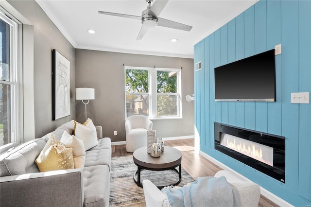 living room with crown molding, hardwood / wood-style flooring, and ceiling fan