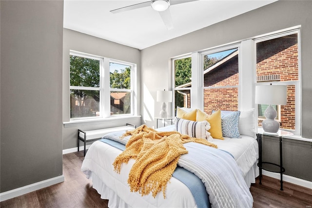 bedroom with ceiling fan and dark hardwood / wood-style flooring