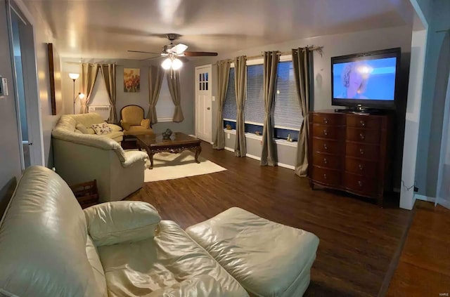 living room with dark hardwood / wood-style flooring and ceiling fan