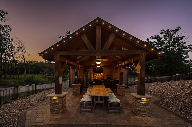 patio terrace at dusk featuring a gazebo