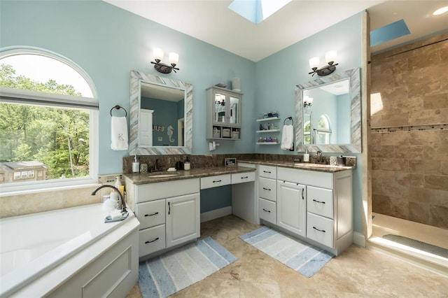 bathroom with a skylight, independent shower and bath, tile patterned floors, and plenty of natural light