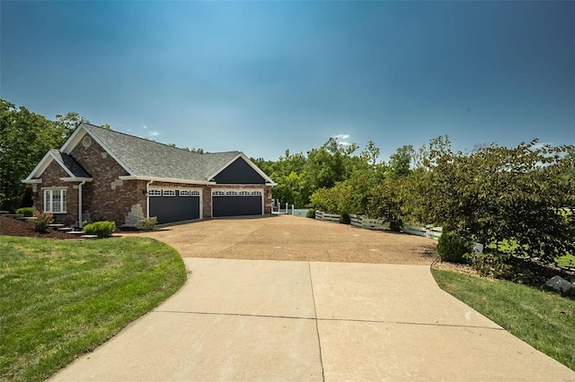 view of front of house with a garage and a front yard