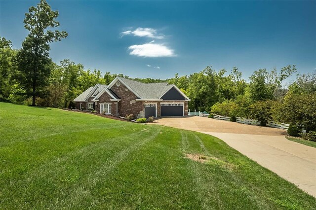 view of front of property with a garage and a front yard