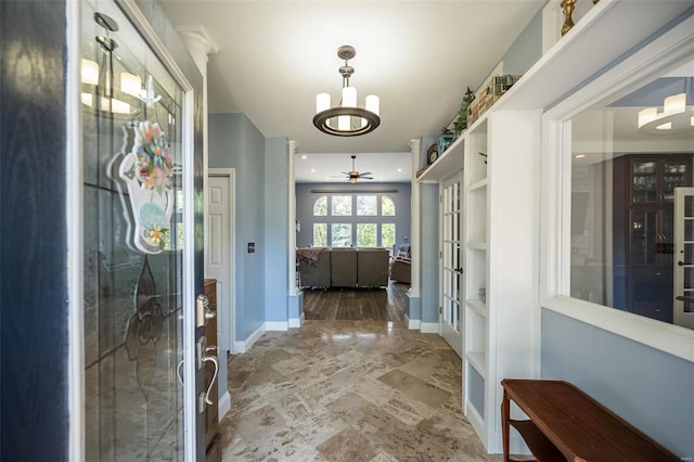 mudroom with tile patterned flooring and ceiling fan with notable chandelier