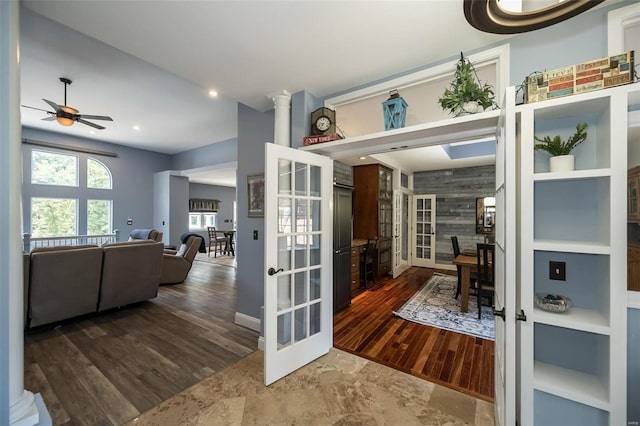 interior space featuring french doors, dark hardwood / wood-style flooring, ornate columns, and built in shelves