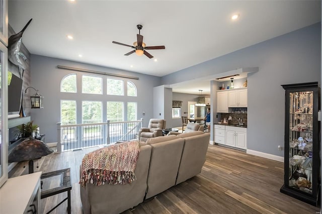 living room featuring wood-type flooring, sink, and ceiling fan