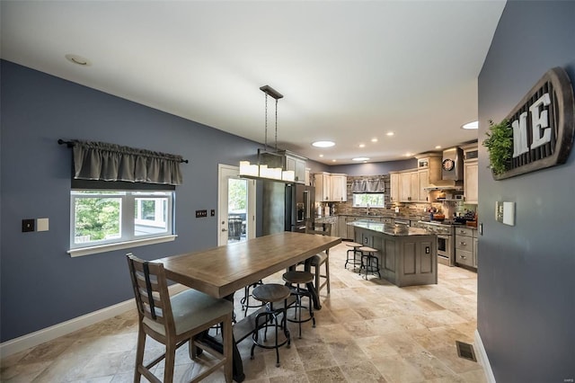 dining room featuring sink and light tile patterned floors