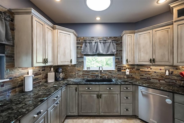 kitchen with sink, dark stone countertops, dishwasher, and tasteful backsplash