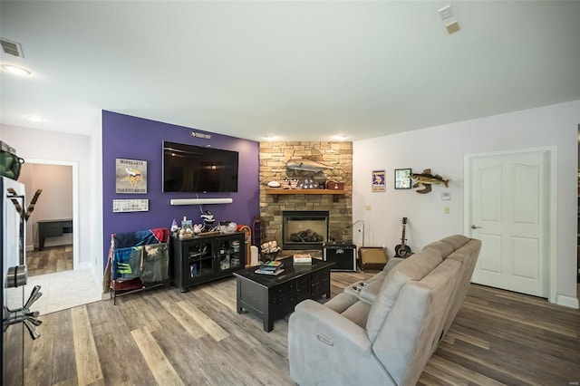 living room with a fireplace and hardwood / wood-style floors