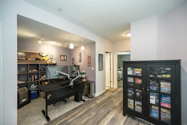 office featuring hardwood / wood-style flooring and rail lighting