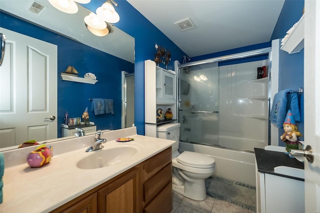 full bathroom with tile patterned flooring, toilet, shower / bath combination with glass door, and vanity