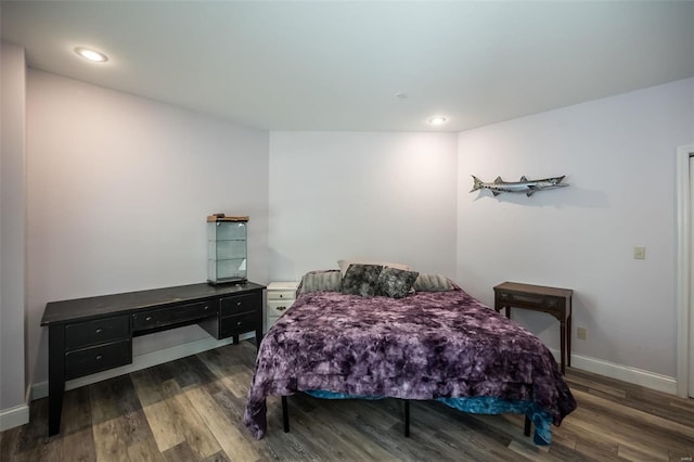 bedroom with dark hardwood / wood-style floors