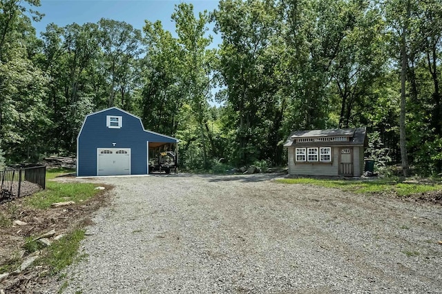 exterior space featuring a garage and an outbuilding