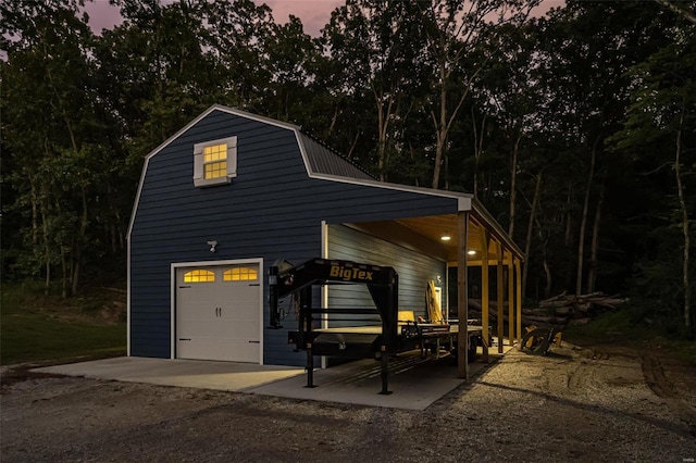 view of garage at dusk