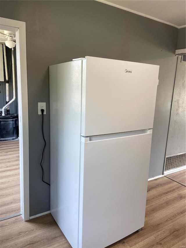 kitchen with white fridge and light hardwood / wood-style flooring