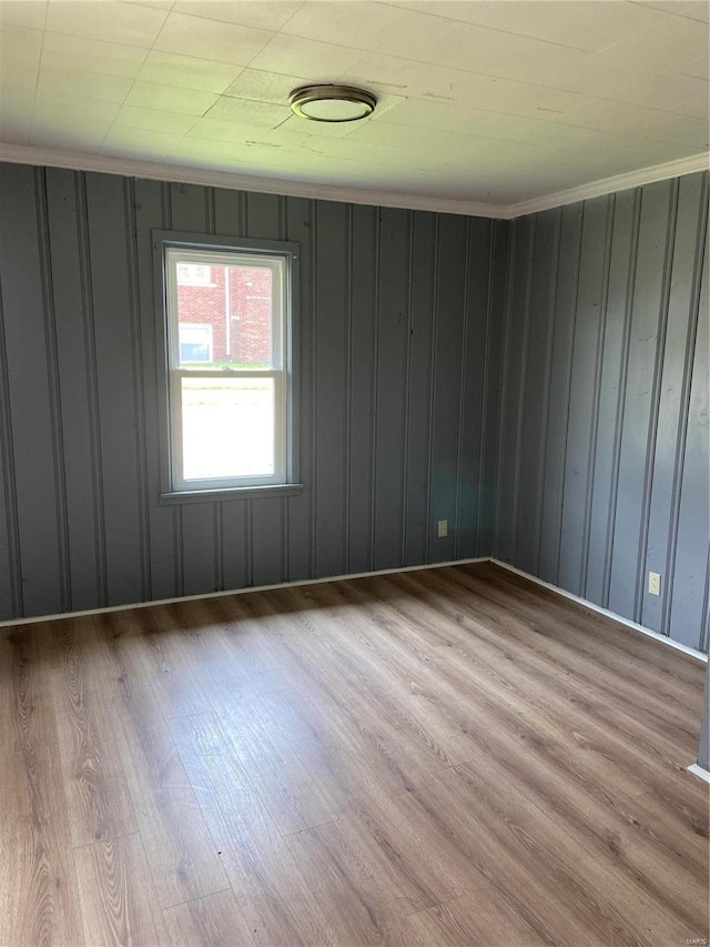 unfurnished room featuring crown molding and light hardwood / wood-style floors