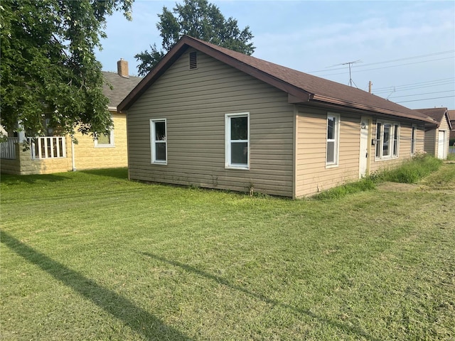 view of home's exterior with a lawn