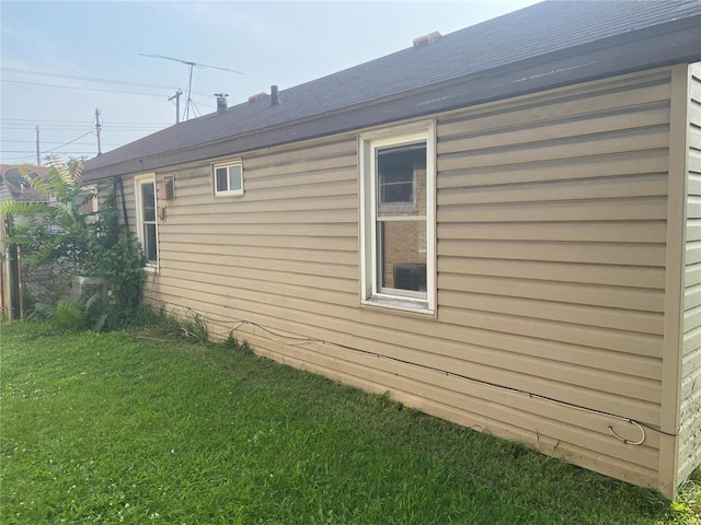 view of side of home with a lawn