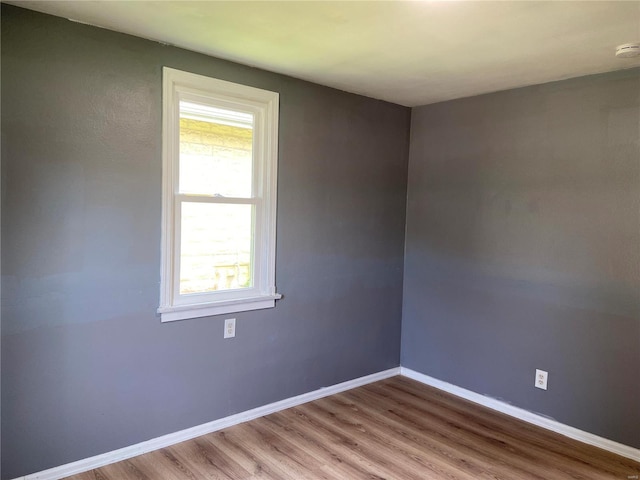 spare room with hardwood / wood-style floors