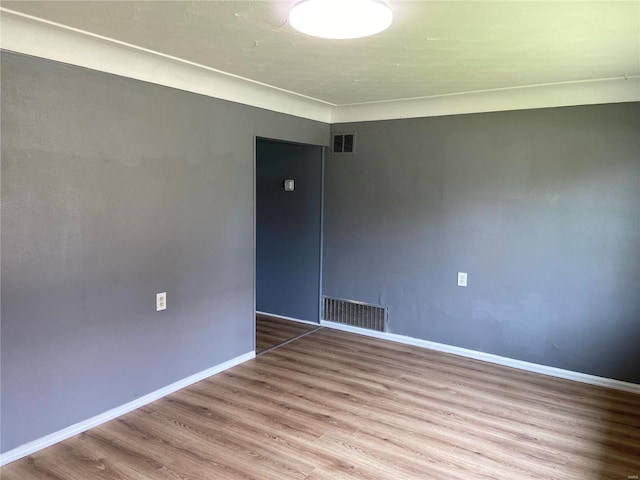 empty room with hardwood / wood-style floors