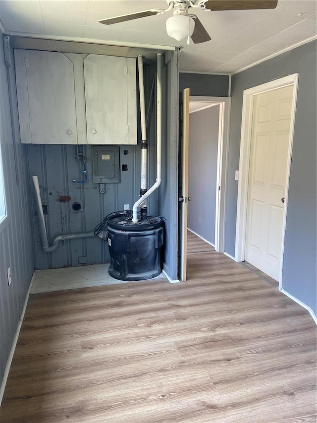 laundry area with light hardwood / wood-style floors and ceiling fan