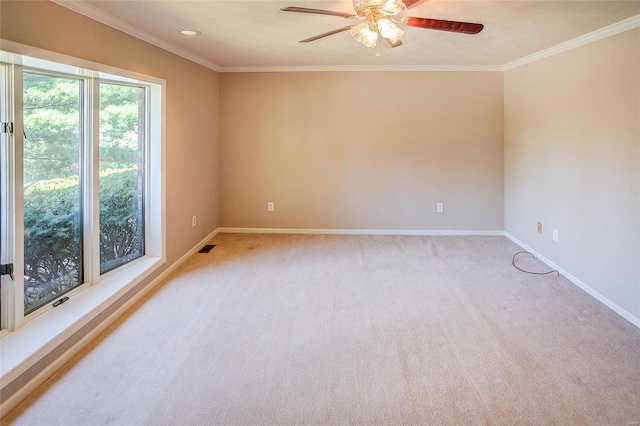 carpeted spare room featuring ornamental molding and ceiling fan